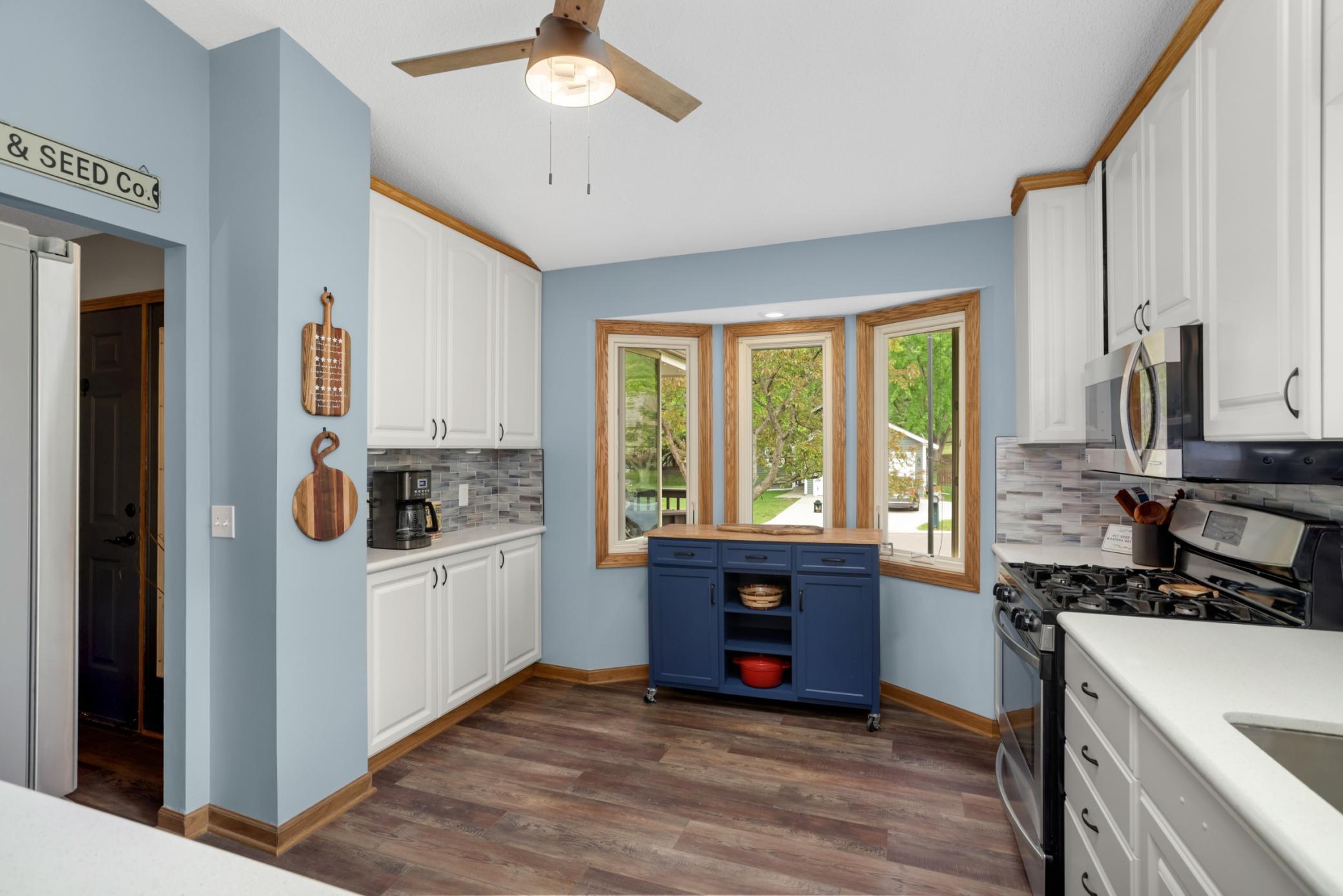 Vaulted ceilings and abundant natural light make the space feel bright and open, while the bay window offers charming neighborhood views and the perfect spot for a coffee bar or additional serving space.