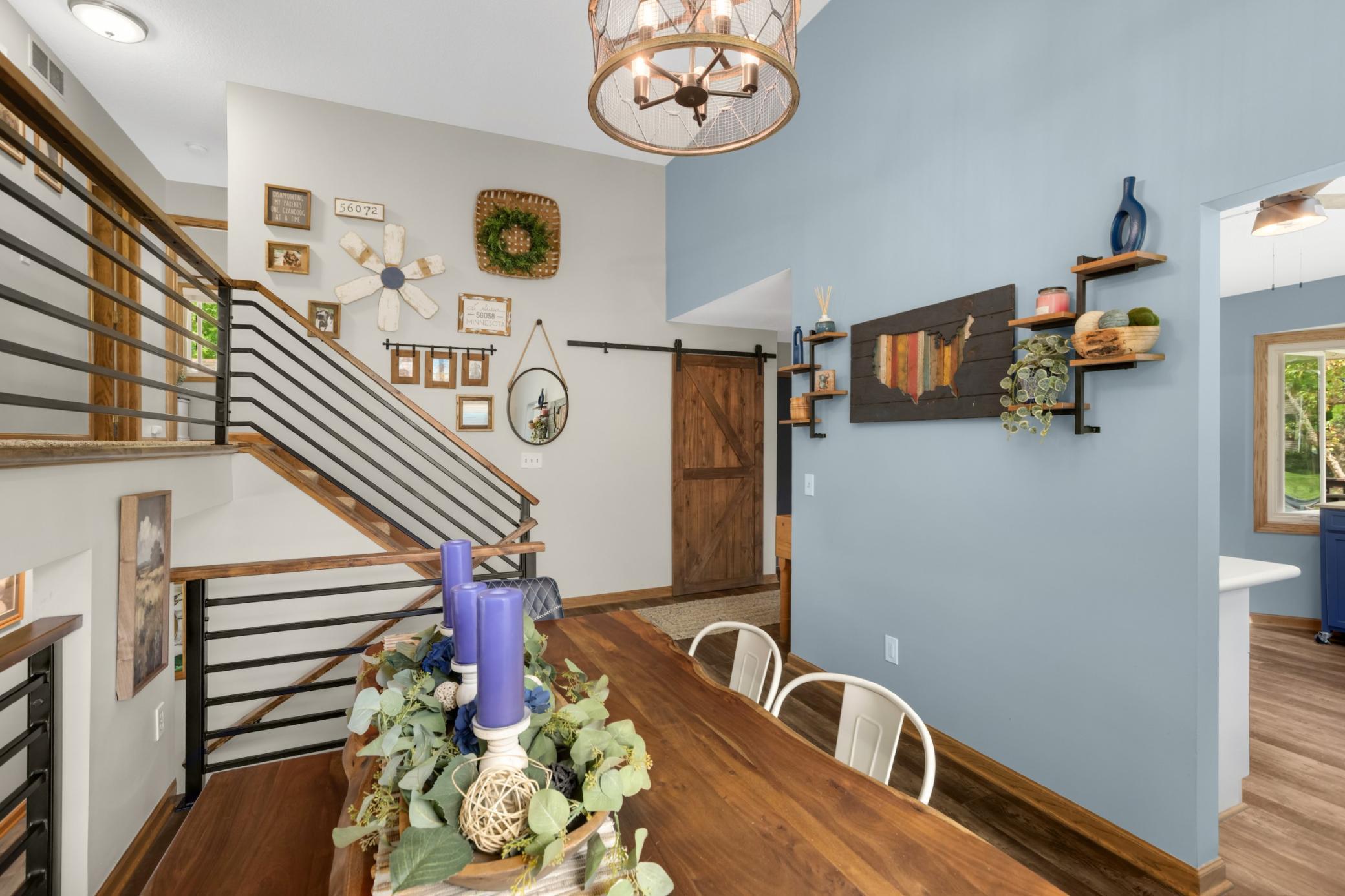 The updated horizontal railing details, and rich wood accents, like the sliding barn door, creates a perfect blend of contemporary and rustic style.