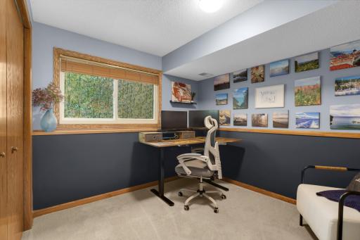 Currently used as a stylish home office, this versatile third bedroom offers the perfect blend of comfort & functionality. The space features soft neutral carpeting, modern two-tone paint, & large daylight windows that bring in tons of natural light