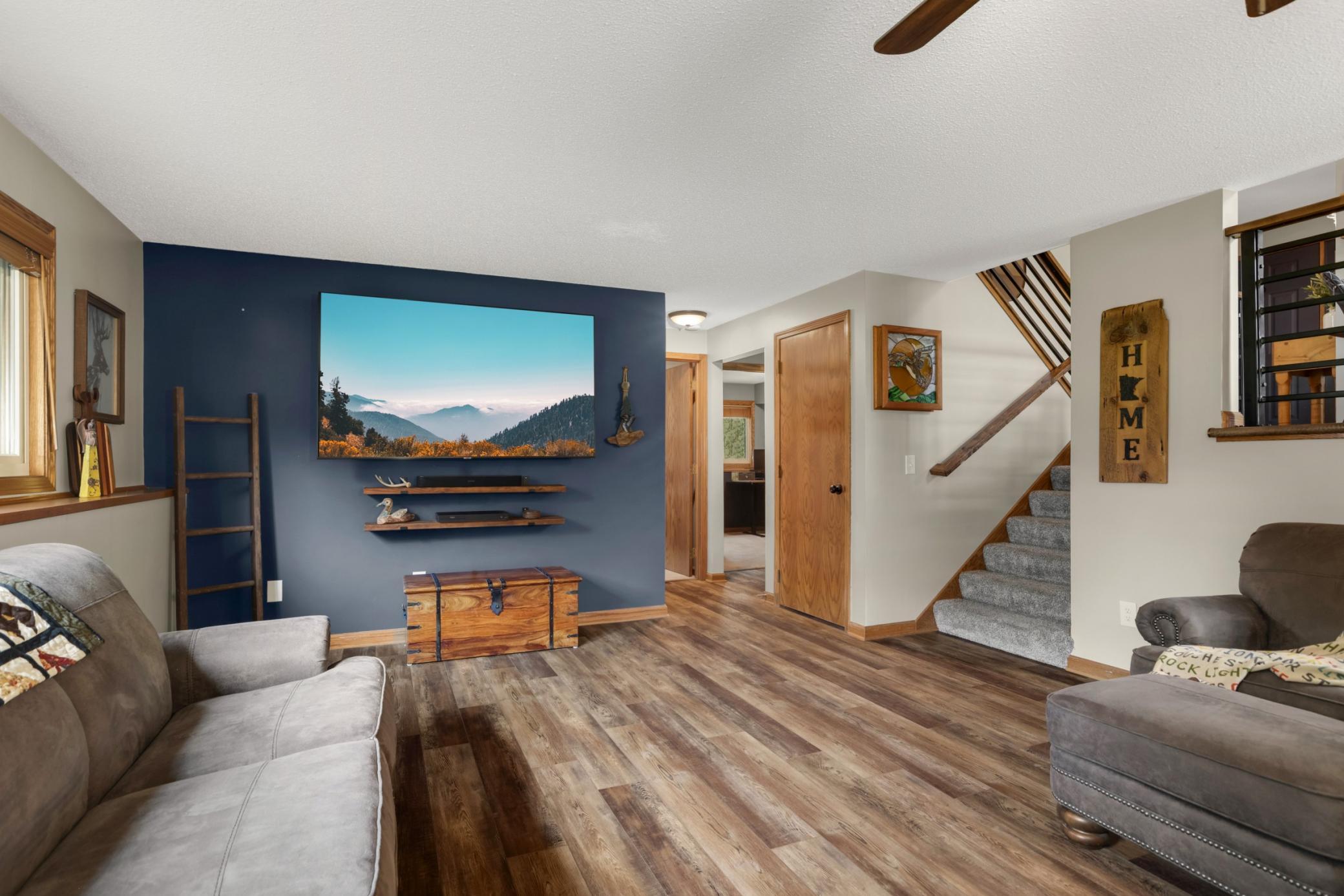 The open layout provides plenty of room for multiple seating areas, making it perfect for movie nights, or everyday living. With its comfortable design, cozy fireplace centerpiece, this lower-level retreat feels both functional & welcoming