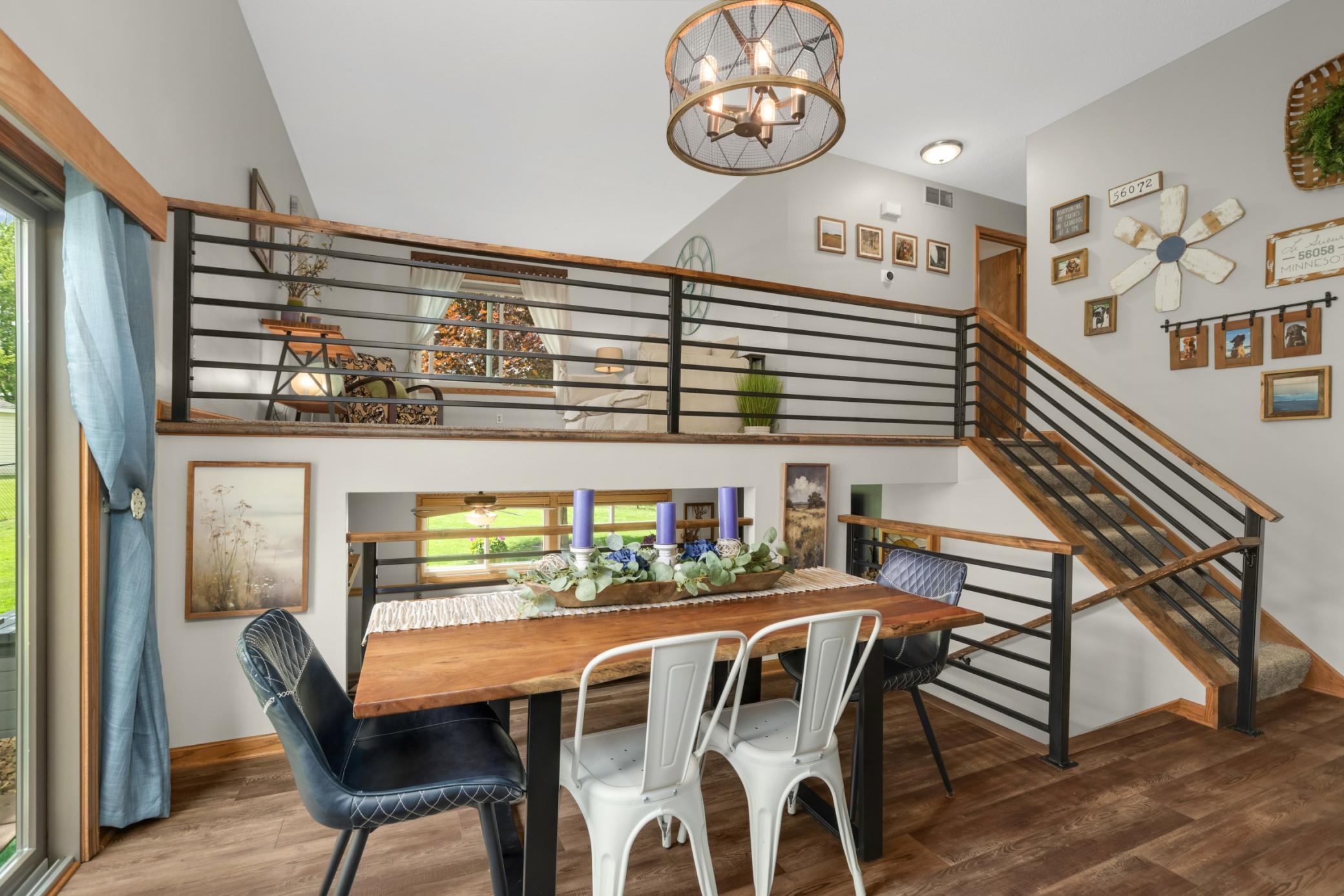 The dining space overlooks the living room above & the family room below, creating an open and connected feel that is ideal for both everyday living and entertaining. The sliding door provides easy access to the backyard.