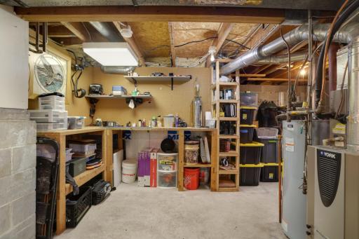 The spacious unfinished lower level features a dedicated workshop area complete with built-in workbenches, shelving, and abundant storage spaceâperfect for hobbies, tools, seasonal items, or home projects.