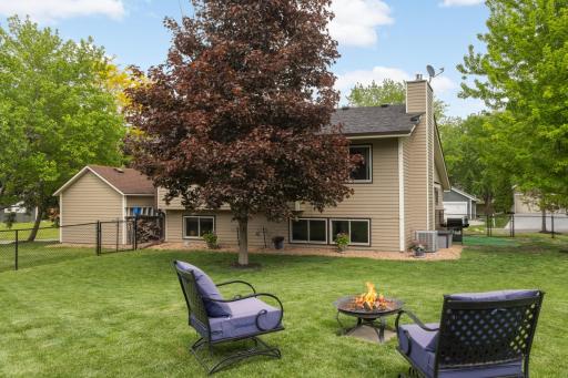 Mature shade trees and well-maintained landscaping create both privacy and natural beauty throughout the yard.