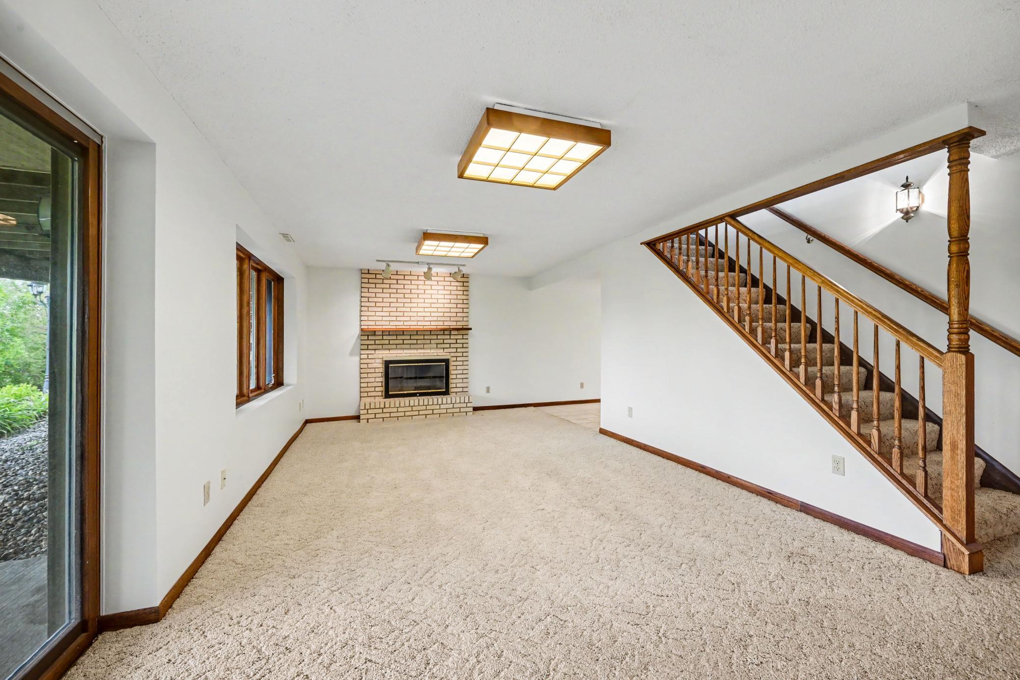The fireplace with brick surround anchors this lovely room