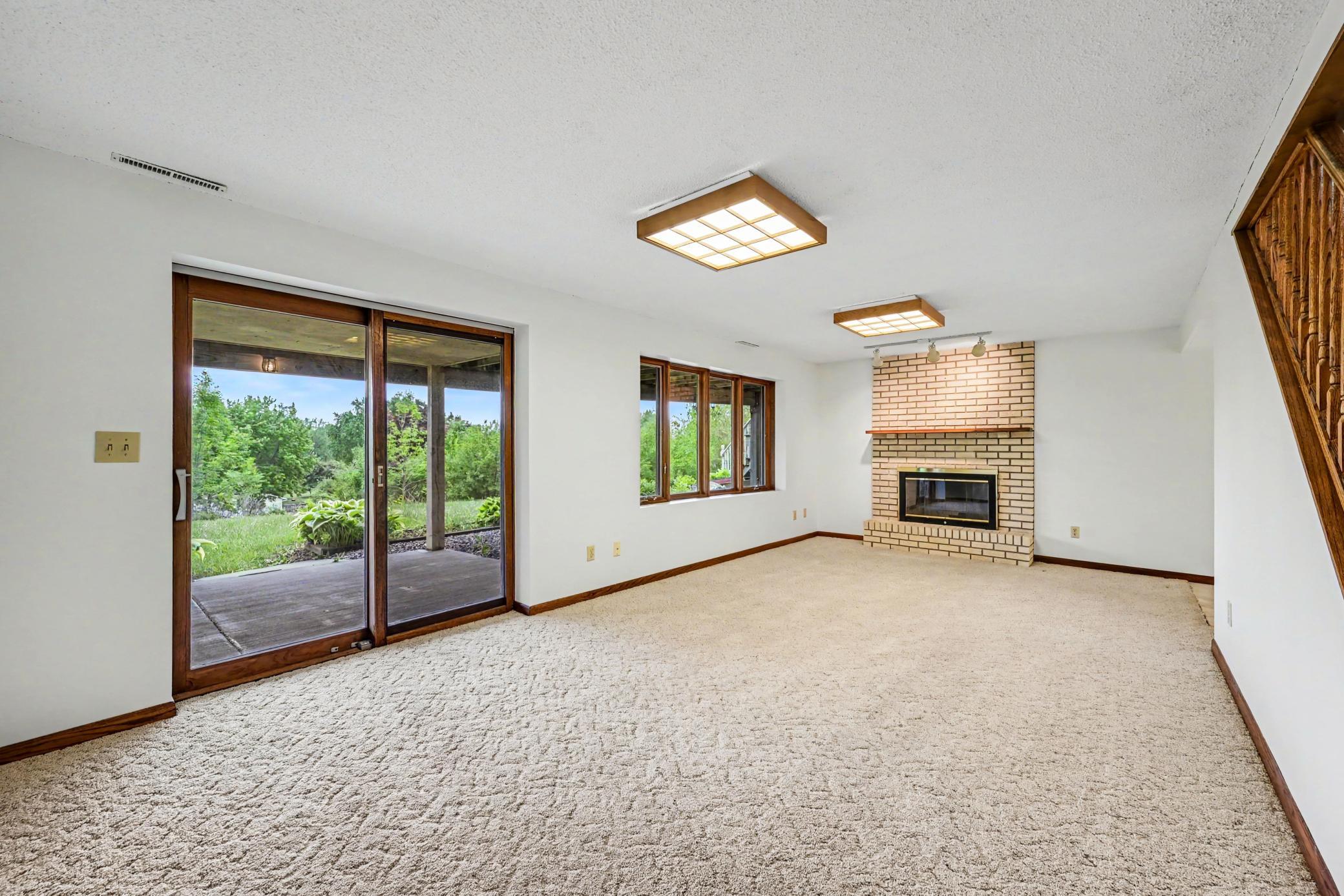 Walk-out basement with patio doors leading to covered concrete patio