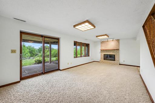 Walk-out basement with patio doors leading to covered concrete patio