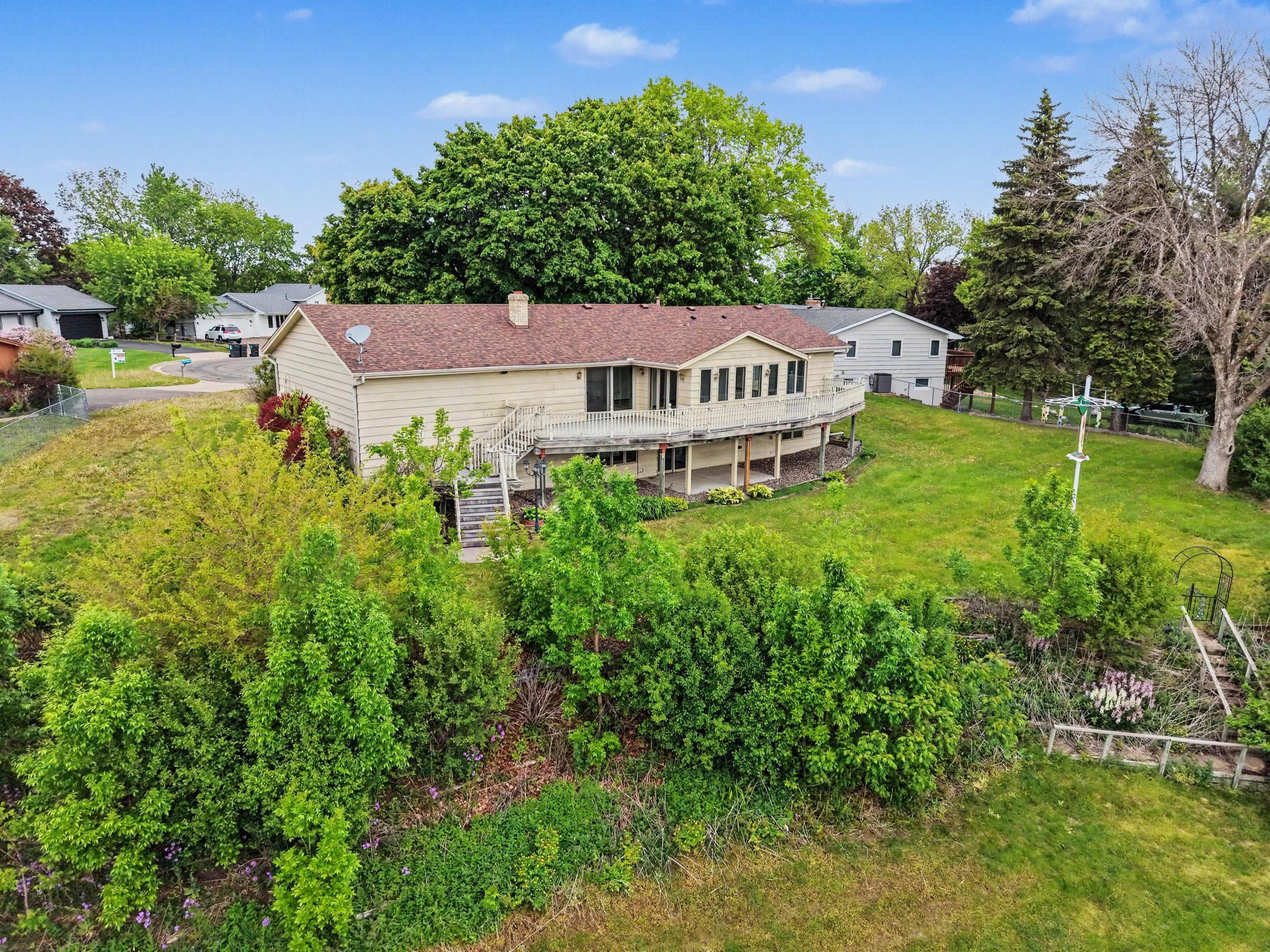 This home sits proudly on a half-acre lot. Part of the lot is level to play yard games and then it rolls into a gentle slope that is tiered with gardens/landscaping.