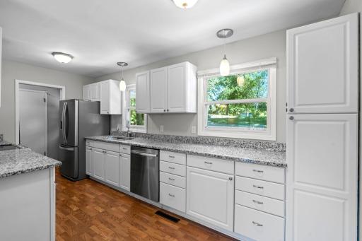 Granite counter tops with stainless steel appliances.