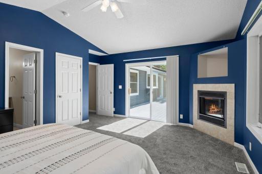 Main-level primary with fireplace, and walkout to maintenance-free deck.