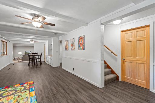 Lover-level amusement room with dry bar and game/entertainment area.