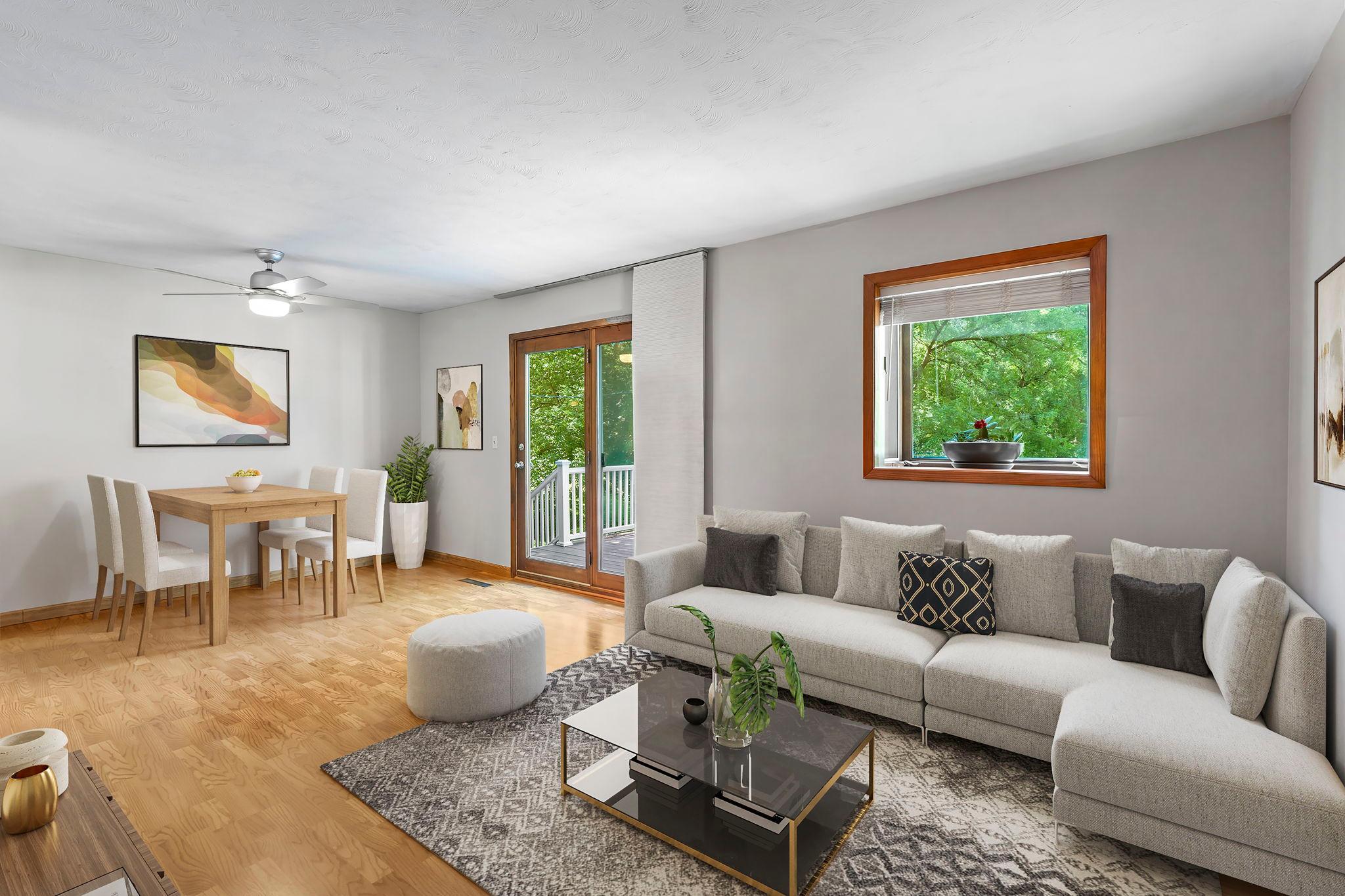 Virtually staged living/dining area with walkout to large deck