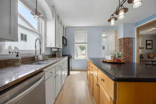 Beautiful kitchen, ceiling height cabinets, exposed brick accent wall