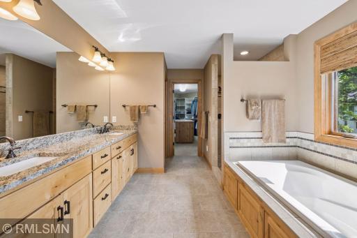 Primary bathroom with full soaking tub, walk-in shower, and in-floor heat
