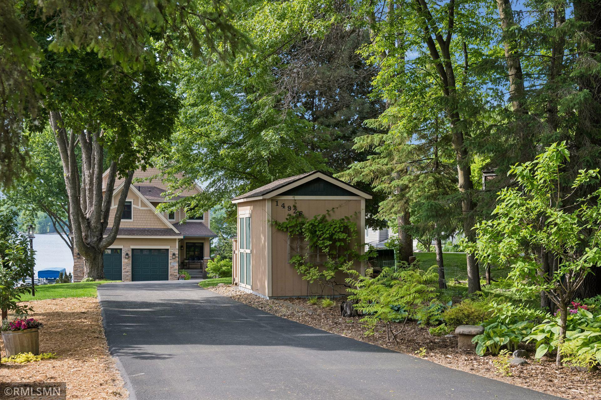 View of the home/driveway/shed/partial flower gardens/vegetable garden to the left from the front of the property near Lori Rd
