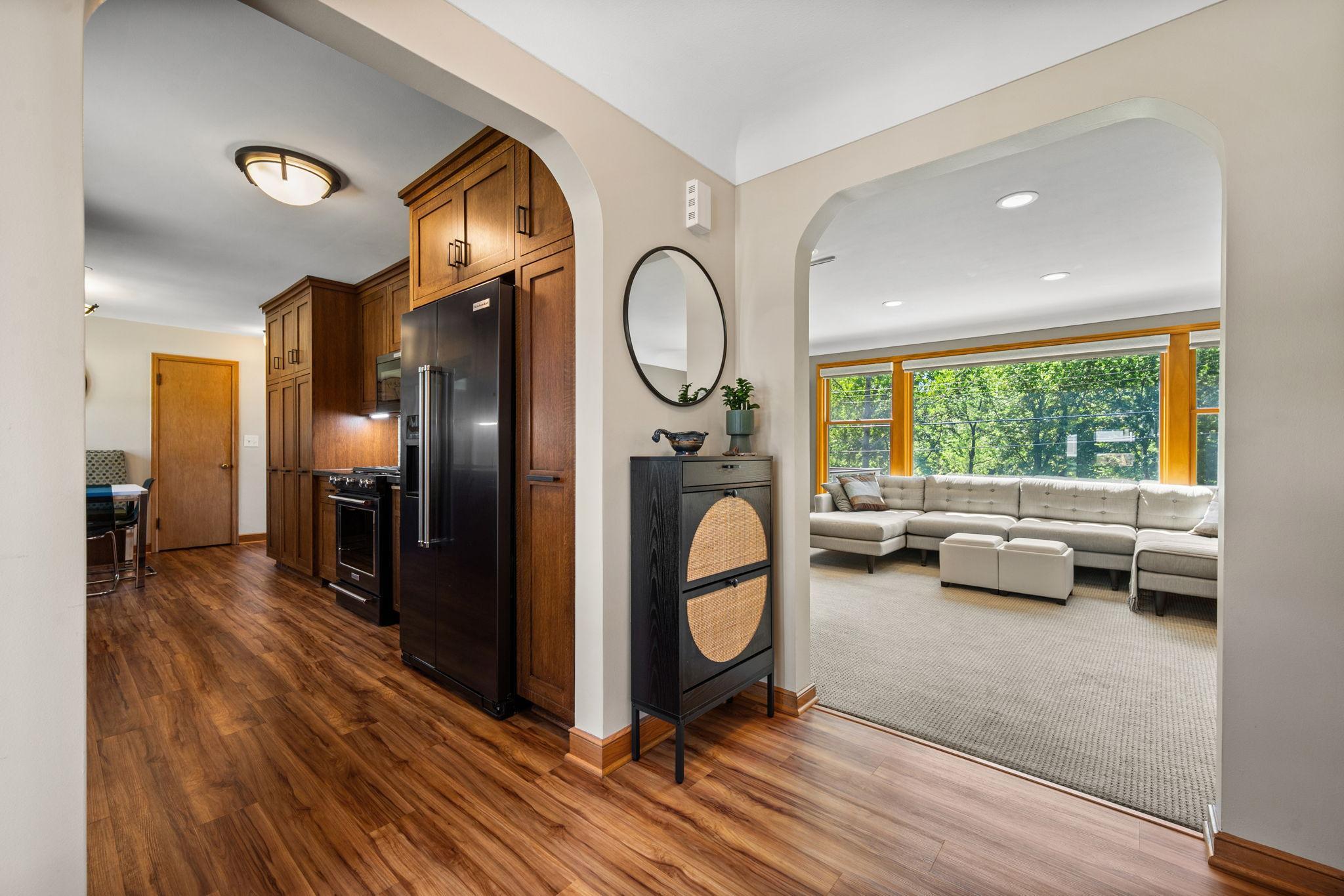 Spacious Entry with Archways Leading to the Kitchen or Living Room