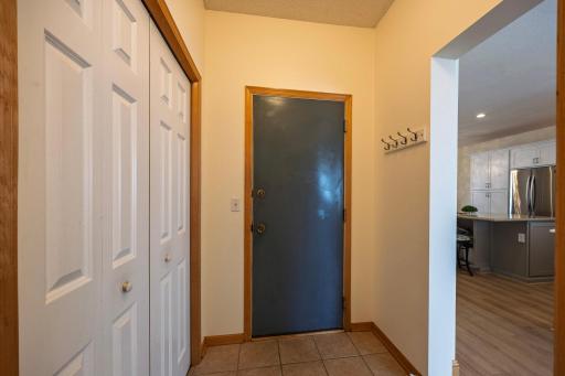 Hallway off entry with Coat Closet and Garage Door!