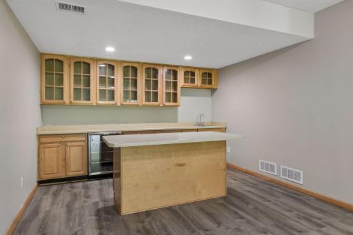Wet bar + an island in the lower level is the perfect place to entertain guests!