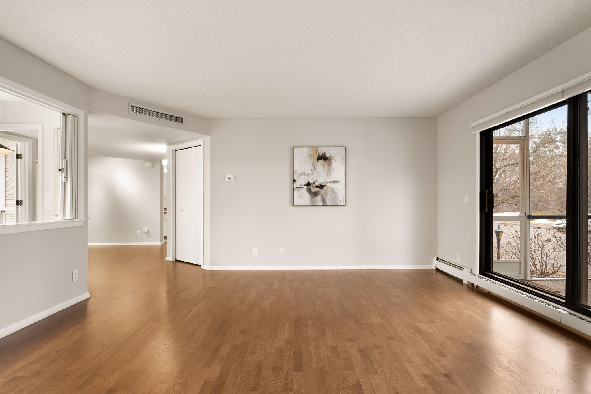 Living room showcasing natural light and flexible furniture layout options.