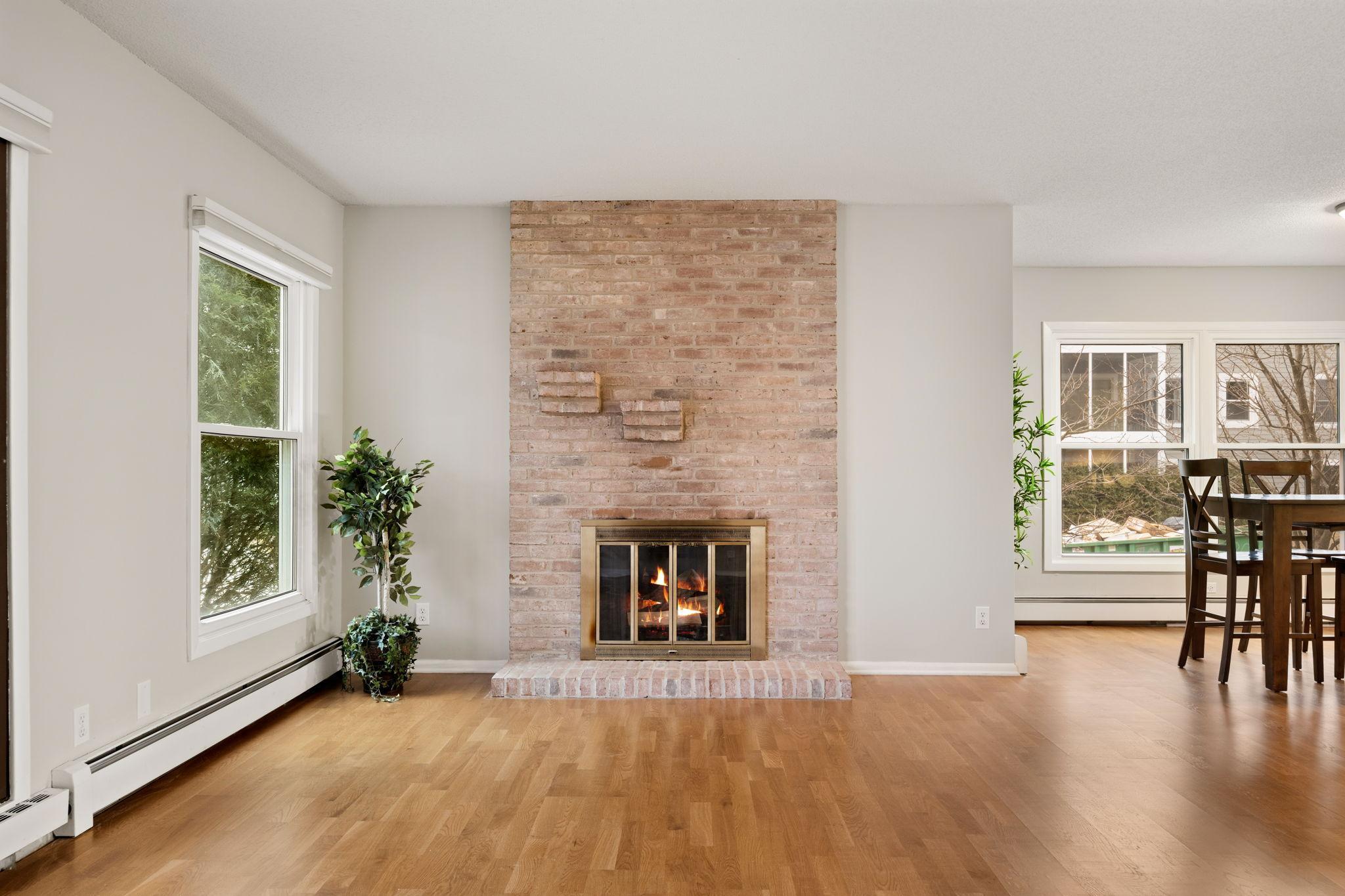 Statement brick fireplace creates a warm focal point in the main living space.