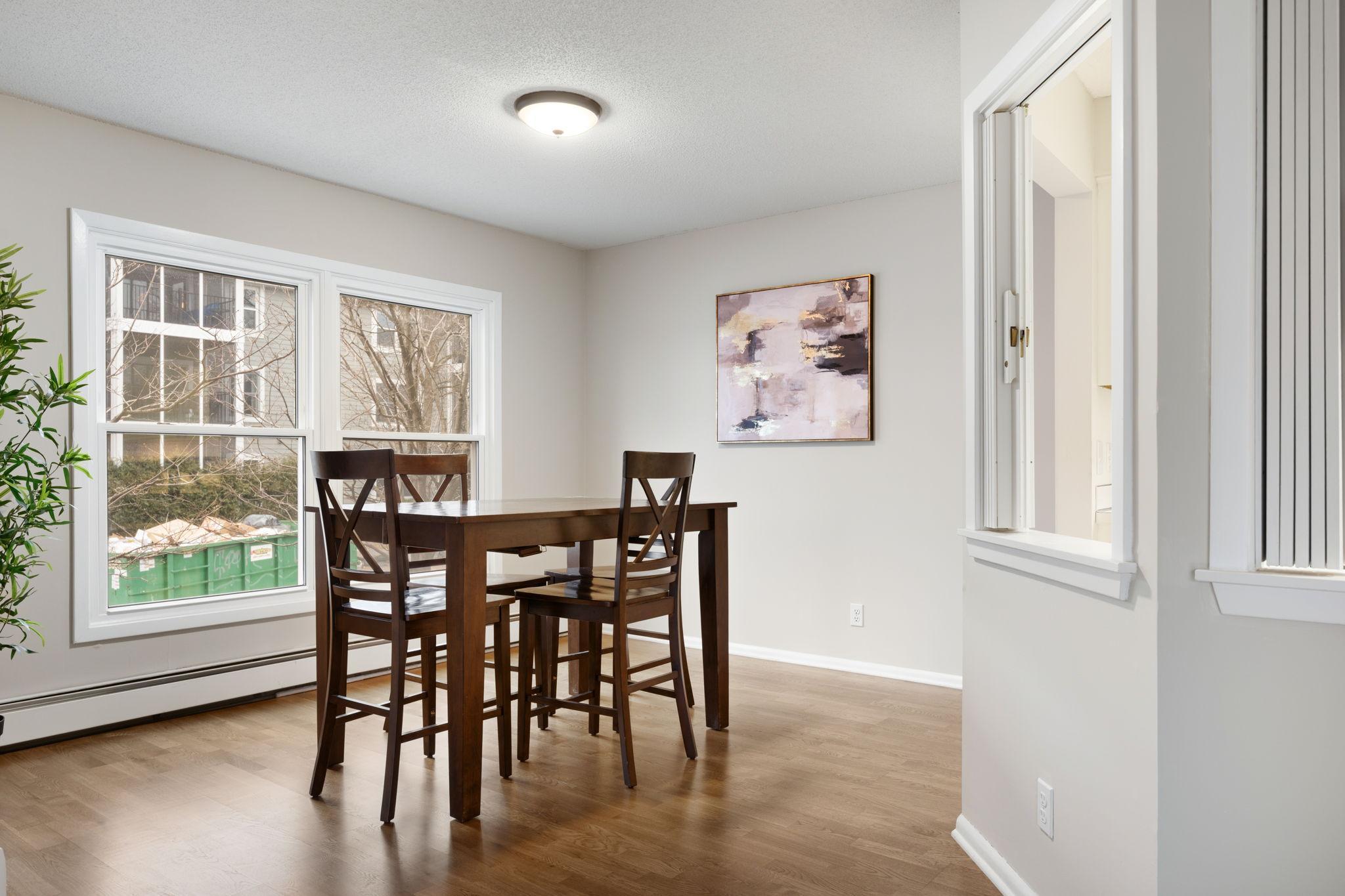 Bright dining area with large windows and room for everyday dining.