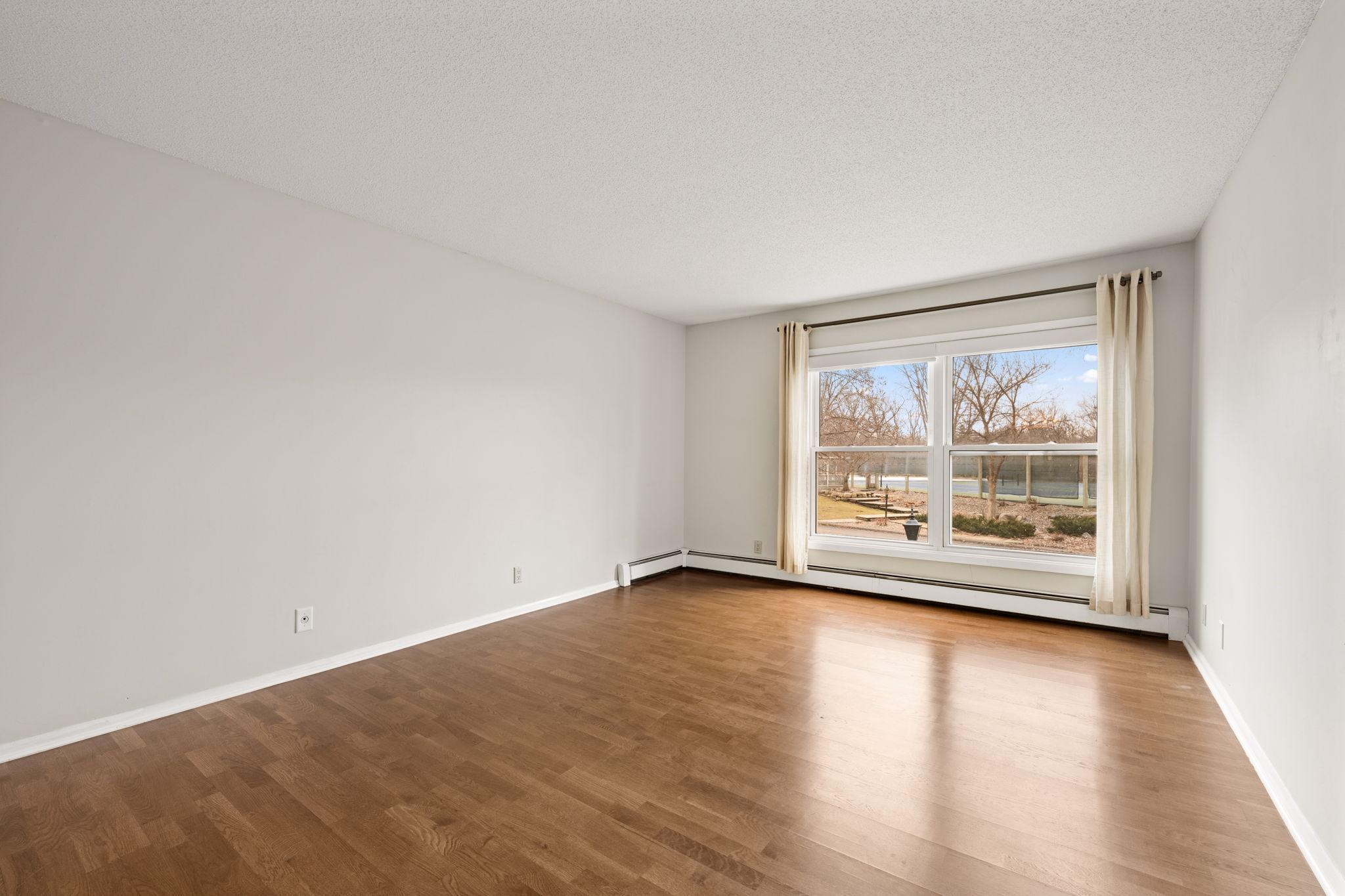 Large Primary bedroom with oversized window and great natural light.