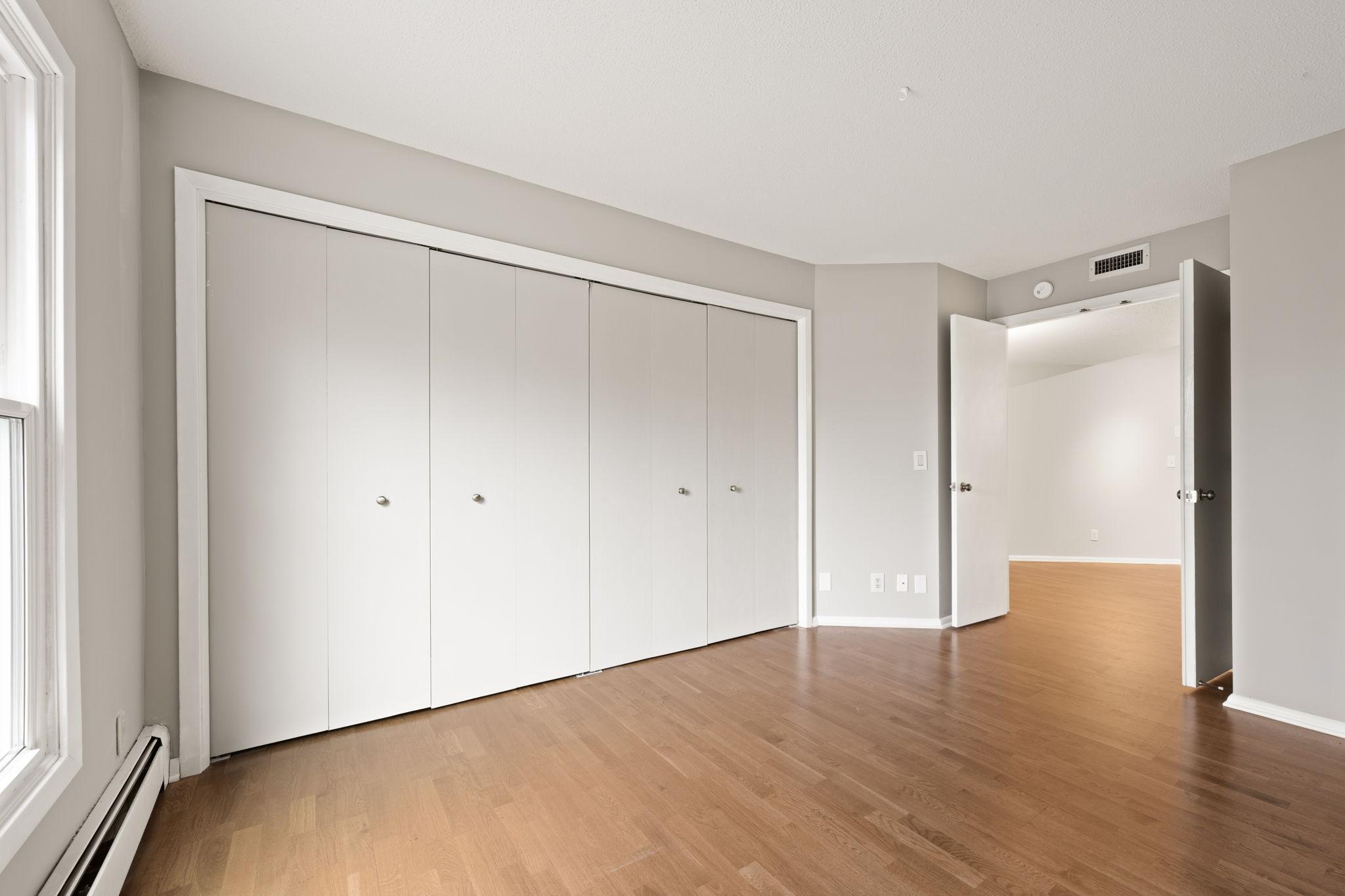 Second bedroom with a full wall of closet space for excellent storage.