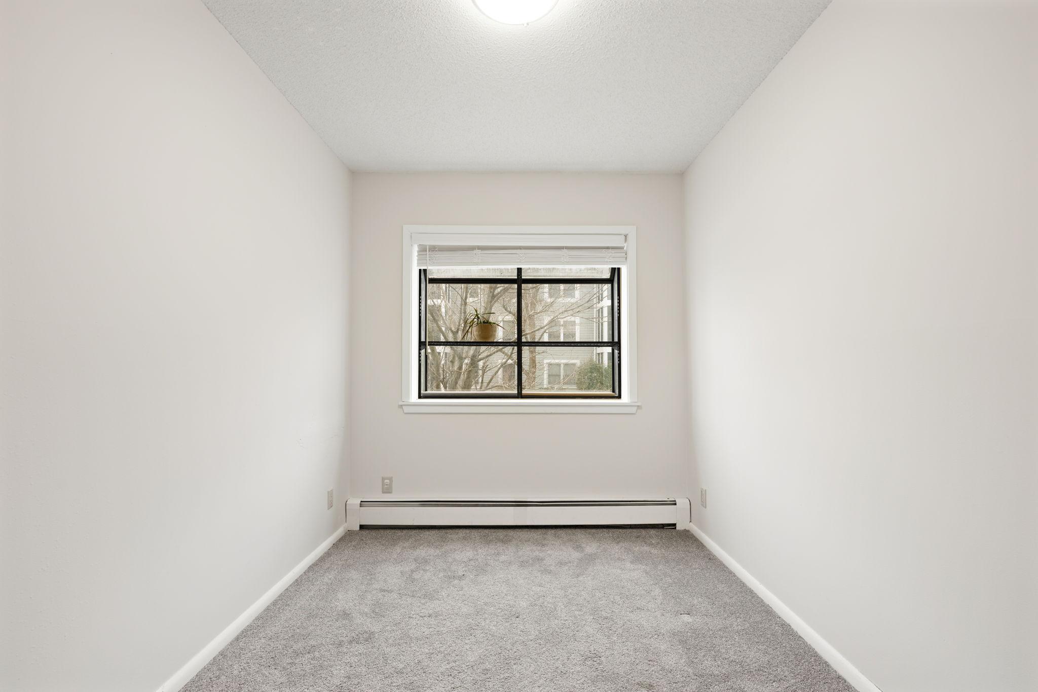 Versatile flex room with window and closet potential for office, hobby, or guest use.