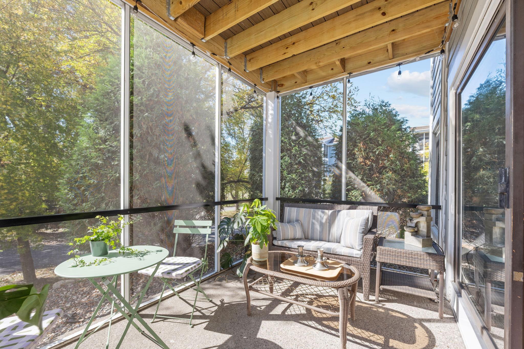 Spacious screened porch with room for seating and seasonal entertaining.