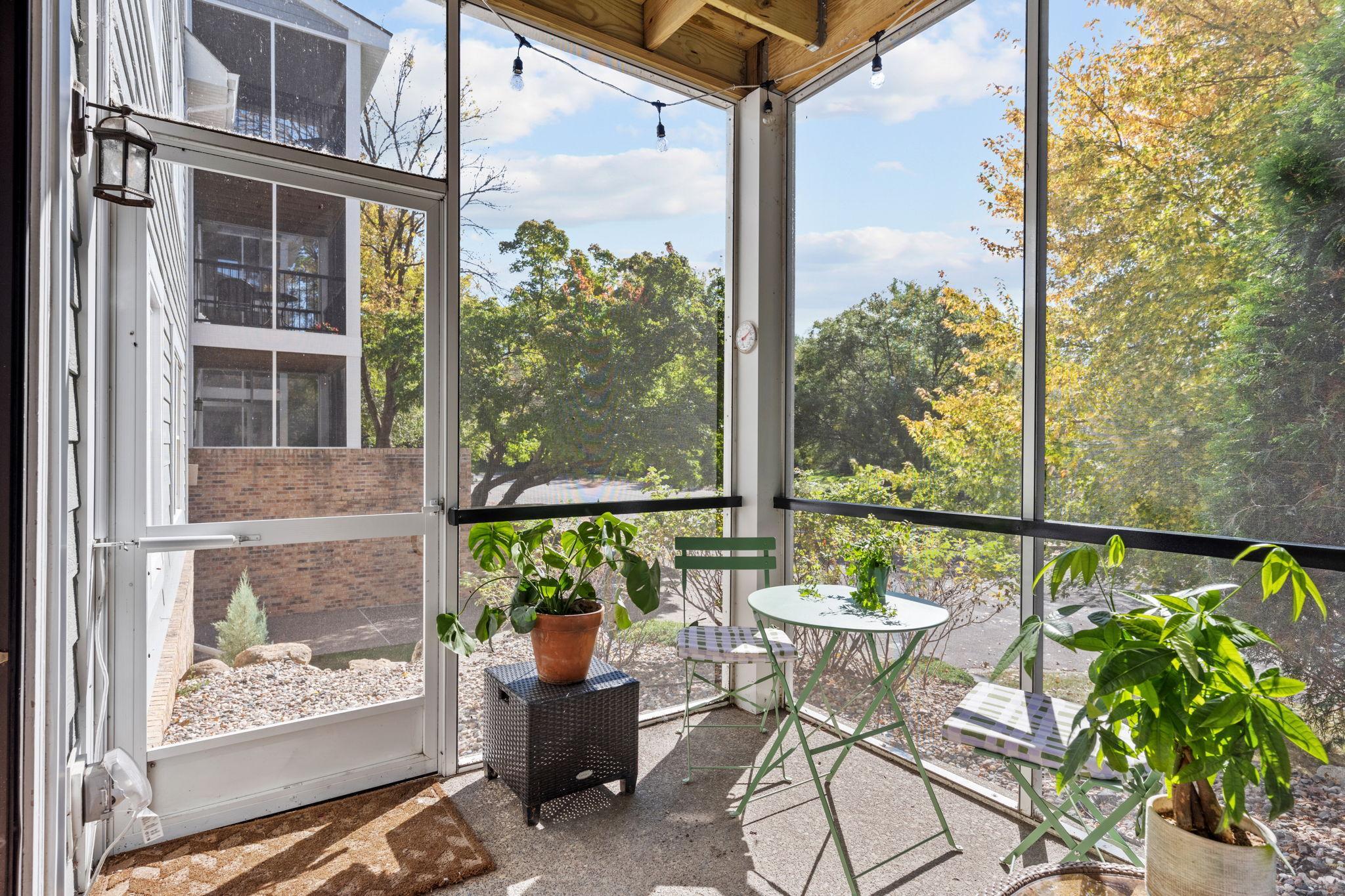 Screened porch with private entrance and views of surrounding greenery.