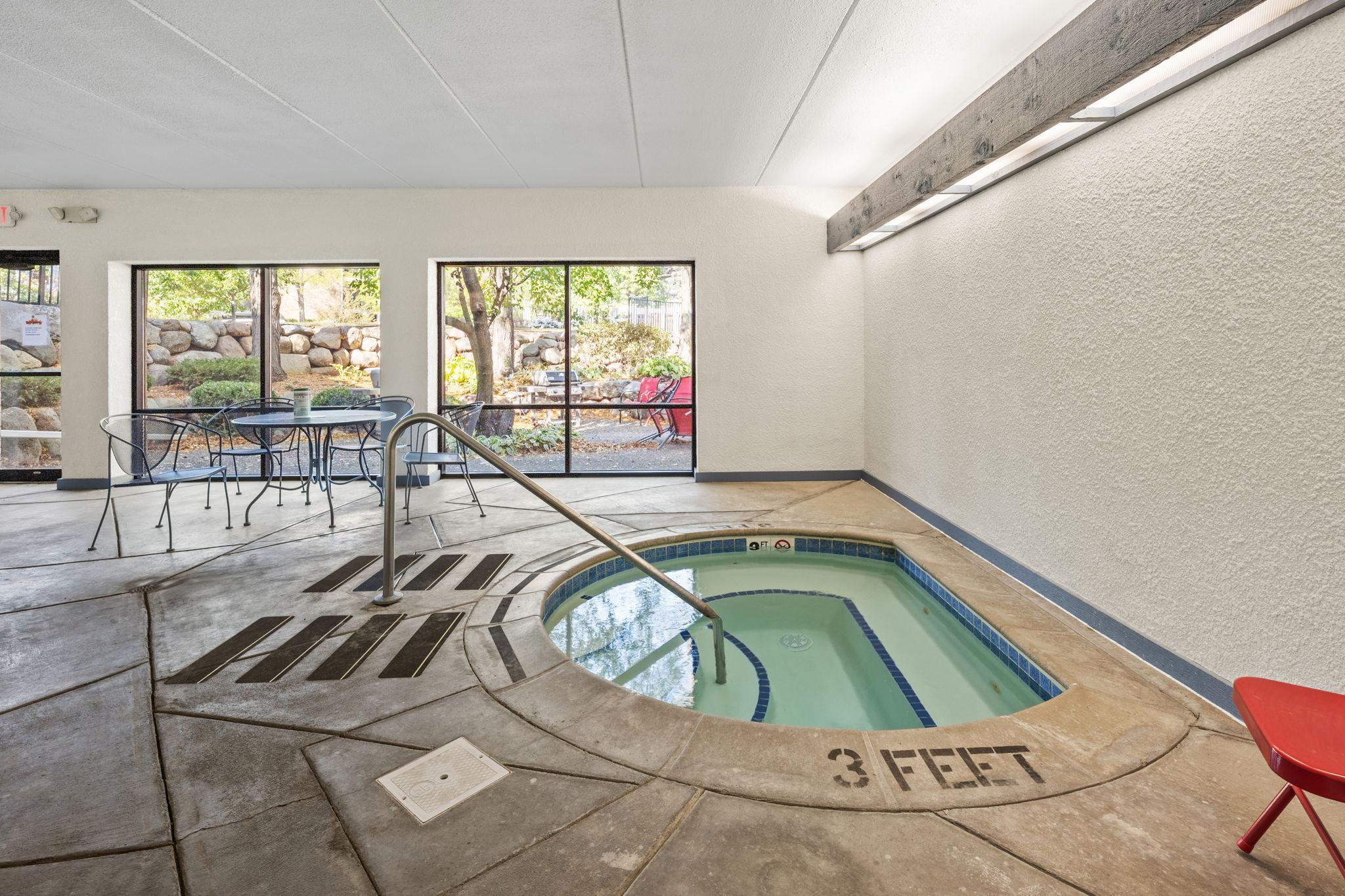 Community hot tub area offers a relaxing amenity for year-round enjoyment.