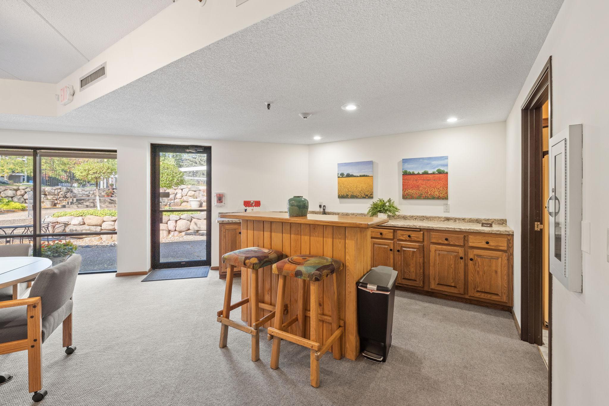 Community entertaining area with serving/bar space and direct outdoor access.
