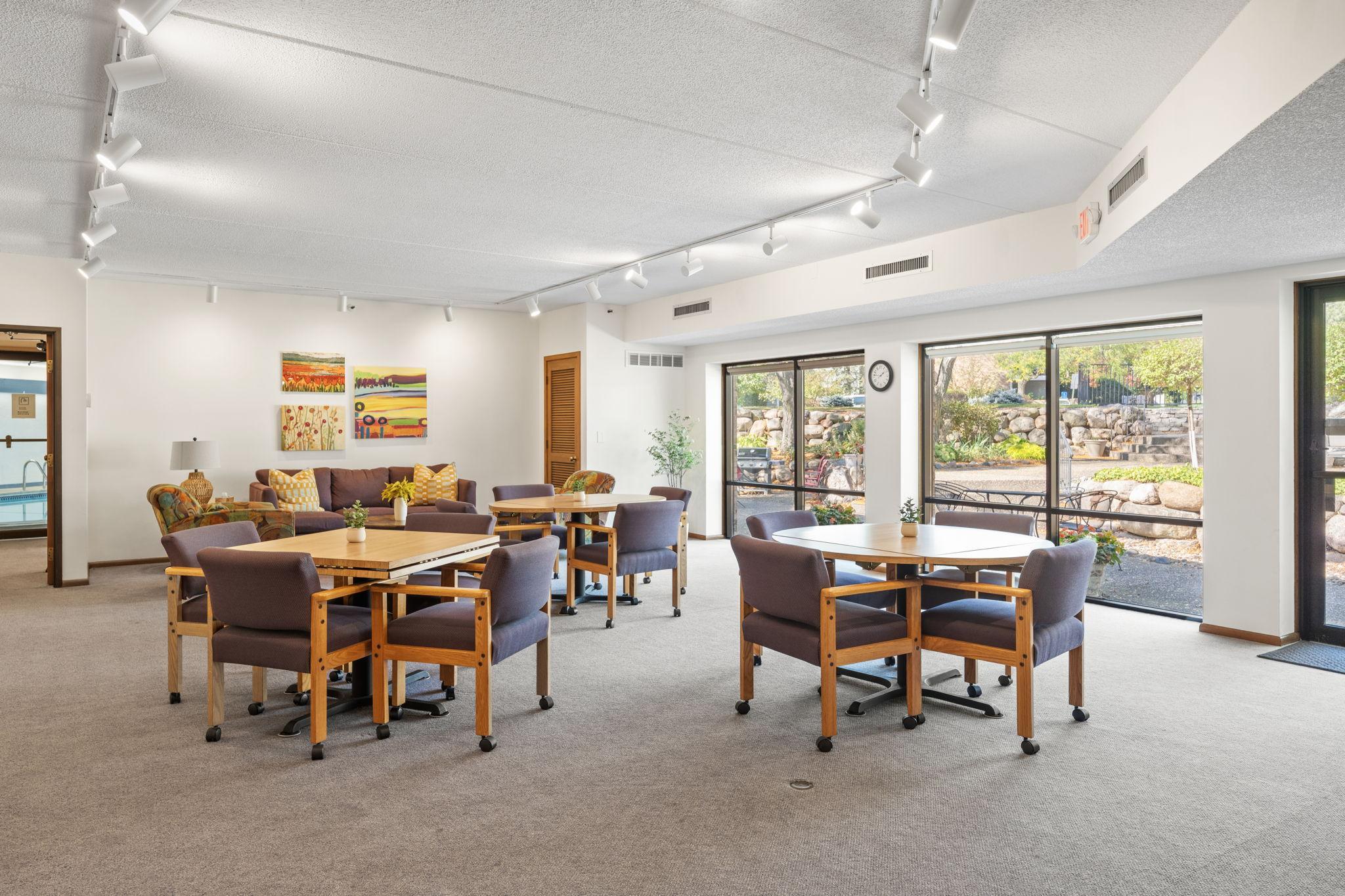 Another view of the community room highlighting flexible seating and gathering space.