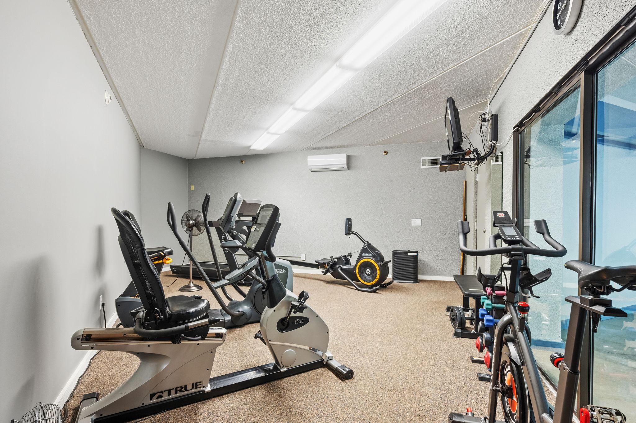 Community fitness room with a variety of exercise equipment.