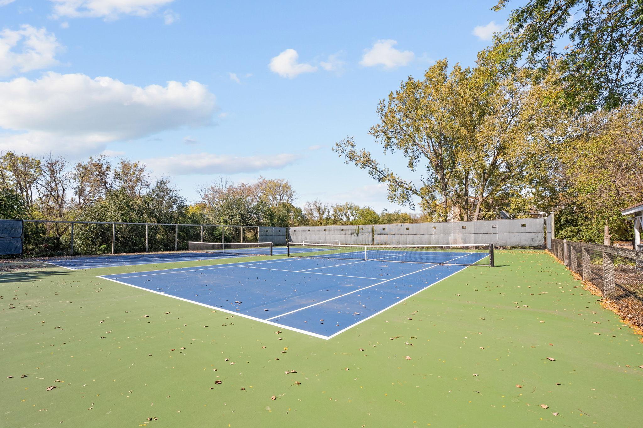 Community tennis court offers space for recreation and active living.
