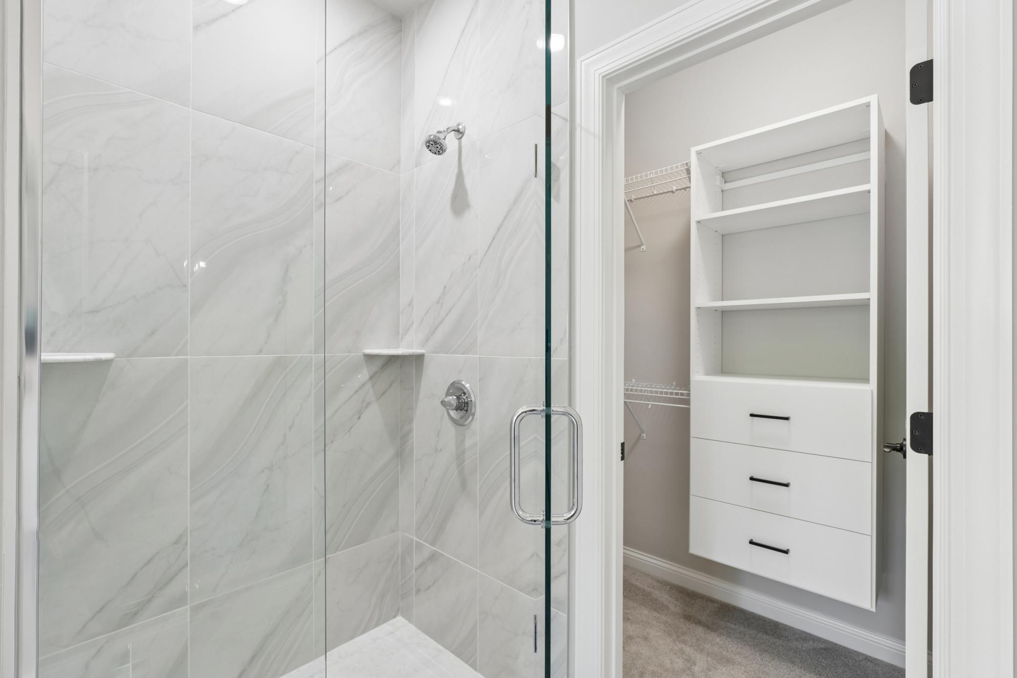 Primary Shower with floor to ceiling Tile