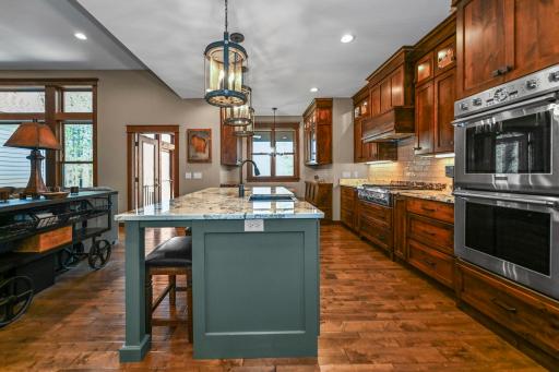 Custom cabinetry, Thermador appliances & a stunning center island create the heart of the home