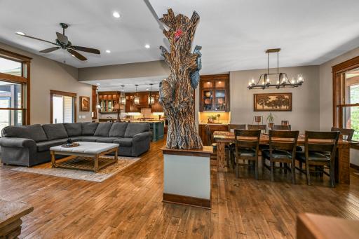 Custom carved woodwork creates a striking focal point between the living & dining spaces