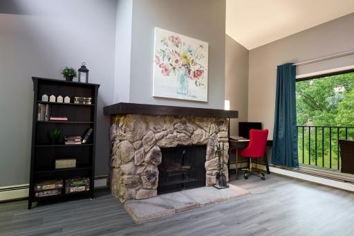 Wood burning fireplace and small desk nook to office from home
