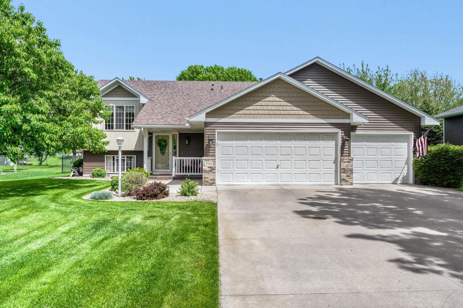 Front view of house - 3 car garage & cement driveway
