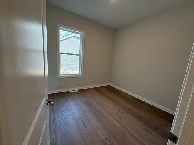 Inviting main-level bedroom with ample space and natural light, offering a serene retreat on the main floor. Its peaceful ambiance makes it perfect for a secondary bedroom.