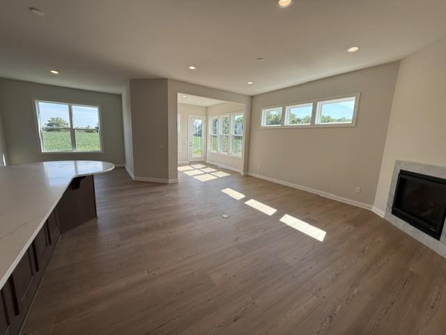 Spacious family room at the heart of the home, featuring soaring 9-foot ceilings and a cozy fireplace that adds warmth and charm.