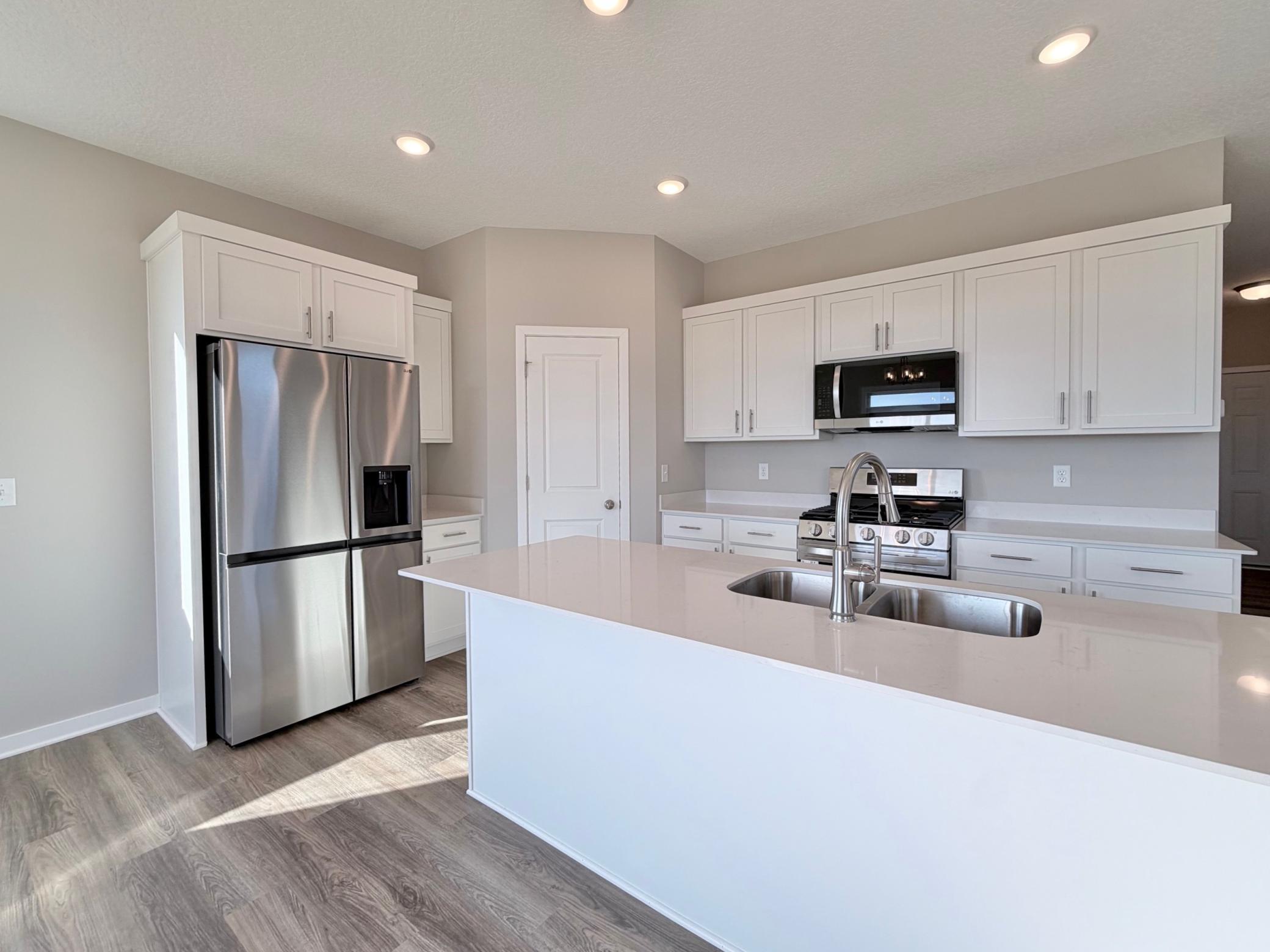 PHOTO OF A DIFFERENT HOME WITH SIMILAR PLAN. FINISHES MAY VARY.