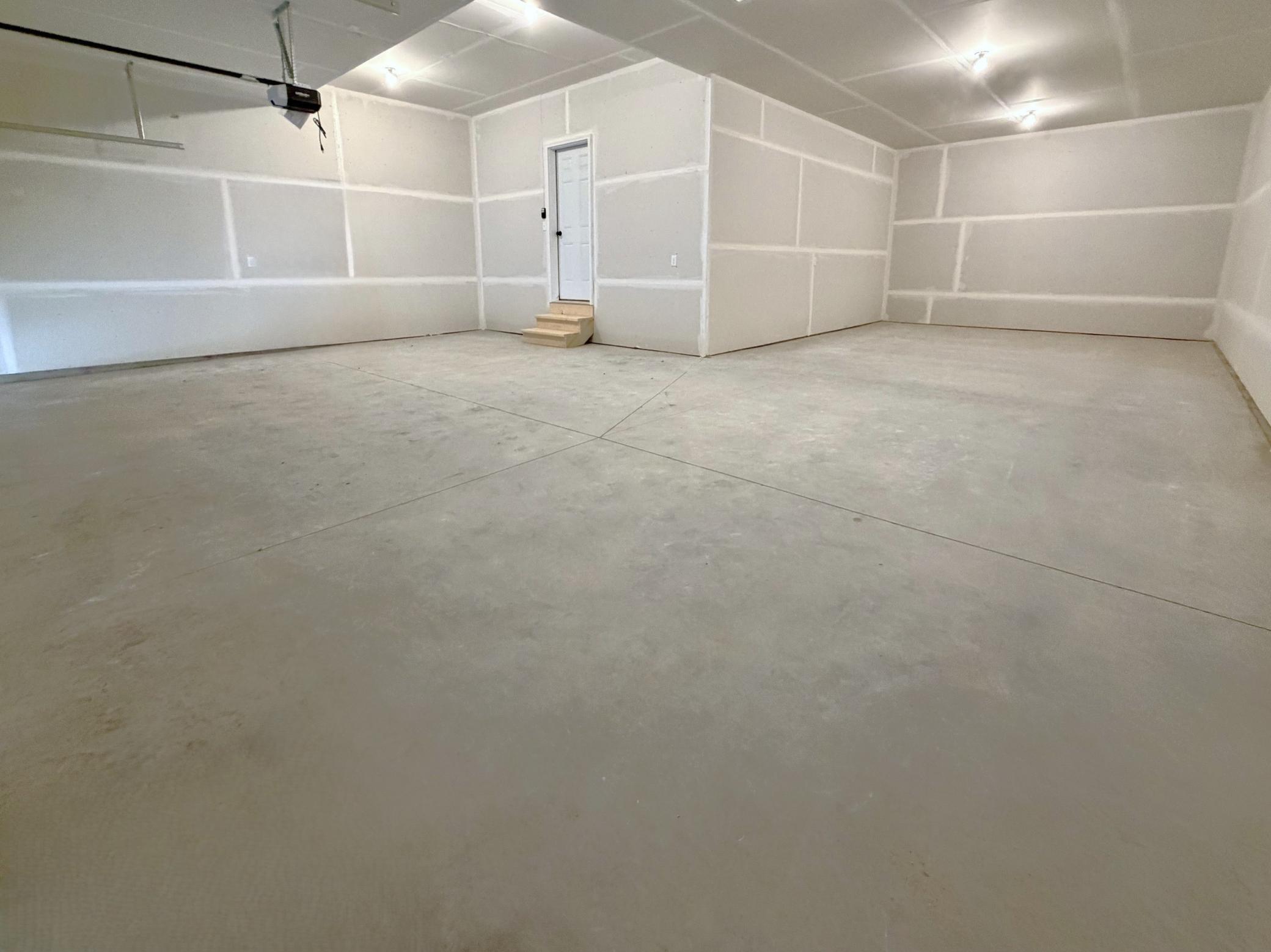 PHOTO OF A DIFFERENT HOME UNDER CONSTRUCTION WITH SIMILAR PLAN AND FINISHES. Spacious 4 Bay Garage features 3 stalls across the front of the home and 4th bay tandem!