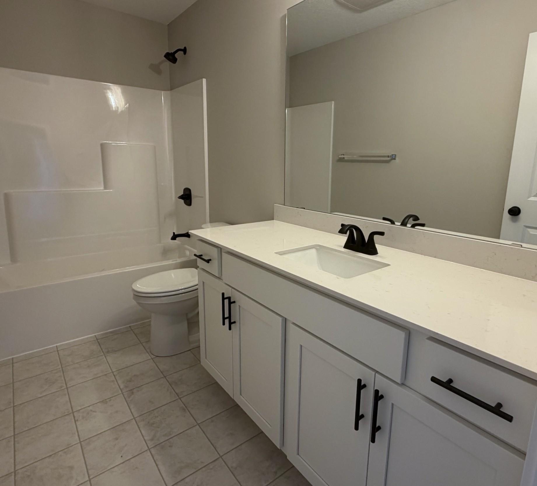 PHOTO OF A DIFFERENT HOME WITH SIMILAR PLAN. FINISHES MAY VARY. Upper Level Main Full Bathroom.