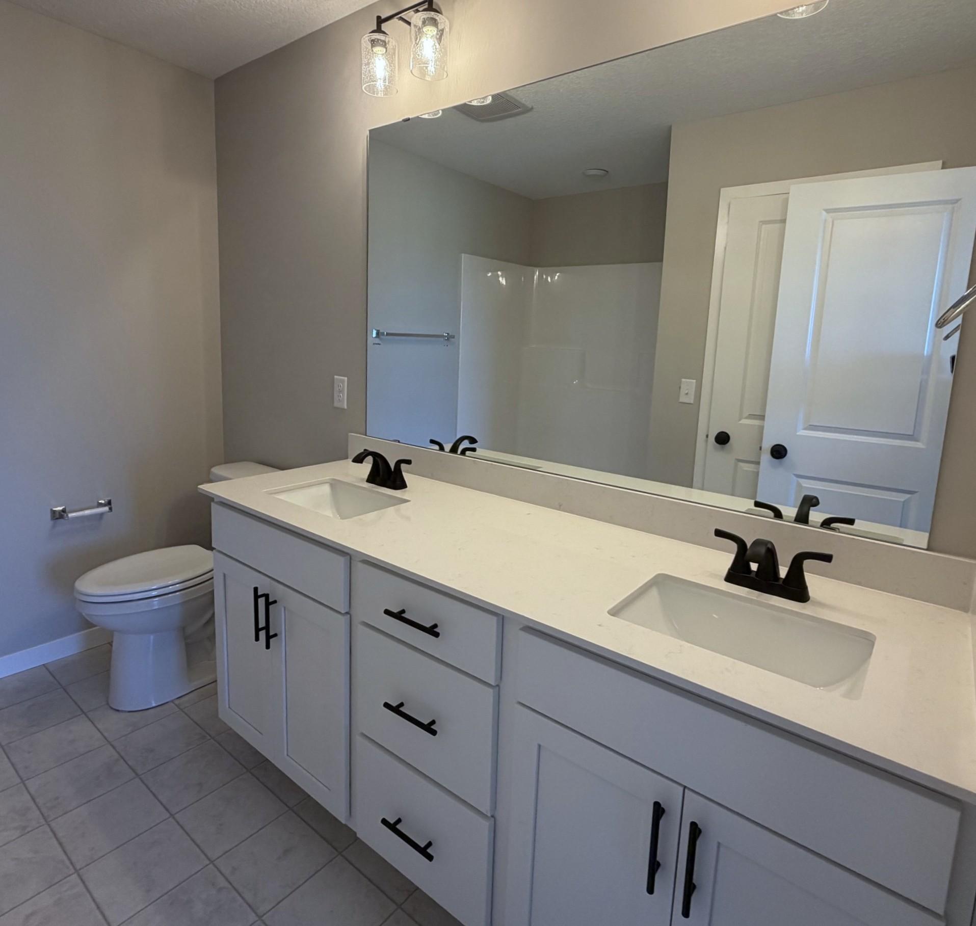 PHOTO OF A DIFFERENT HOME WITH SIMILAR PLAN. FINISHES MAY VARY. Primary Suite Private Bathroom.