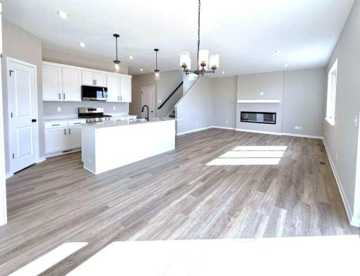PHOTO OF A DIFFERENT HOME WITH SIMILAR PLAN. FINISHES MAY VARY. Dining room view to the kitchen and great room.