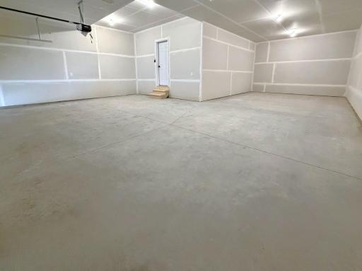 PHOTO OF A DIFFERENT HOME WITH SIMILAR PLAN. FINISHES MAY VARY. Spacious 4 BAY GARAGE features 3 stalls across the front and 4th bay tandem offering abundance for space for storage and work area.