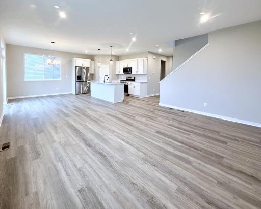 3153 Jandura Ave NE-Great Room open to dining and kitchen featuring LVP flooring.