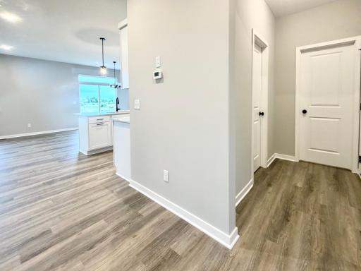 3153 Jandura Ave NE- Hallway view to the mudroom featuring a Walk-in Closet and Half Bath.
