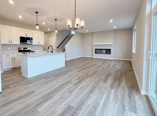 PHOTO OF A DIFFERENT HOME WITH SIMILAR PLAN. FINISHES MAY VARY. Great Room features a fireplace.